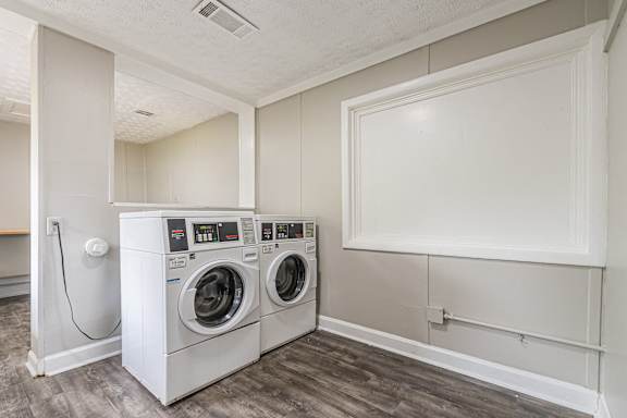 Two front loading washing machines in a laundry room at Pinewood Townhomes, Tucker, 30084