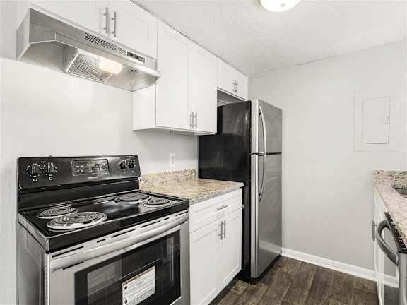 Kitchen with black appliances at Pinewood Townhomes, Tucker, GA, 30084