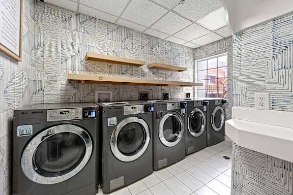 A row of washing machines in a laundromat.