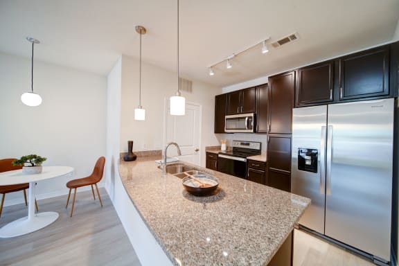 apartment kitchen with granite countertops and stainless steel applicances