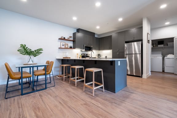 a kitchen and dining area with a table and chairs at Sonder Fields Apartments, Happy Valley, Oregon, 97015