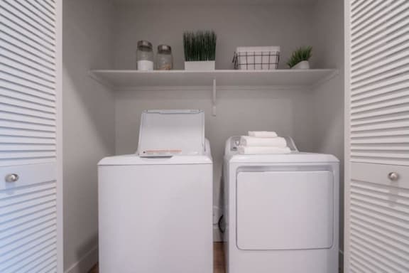 a small laundry room with two washes and a dryer at Sonder Fields Apartments, Happy Valley, 97015