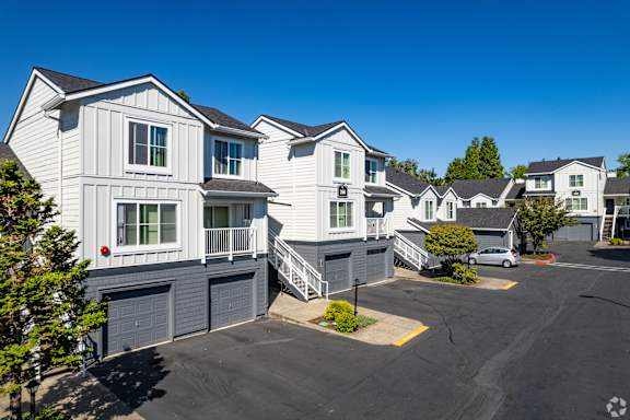 A row of houses with a clear blue sky above them.