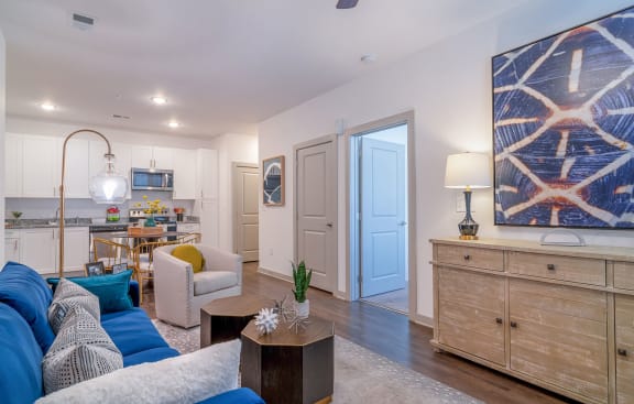 a living room and kitchen with a blue door at Carmel Vista, McDonough, GA, 30253