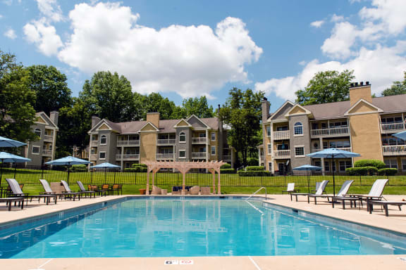 Pool surrounded by lounge chairs and buildings beyond that at Madison Glen Mills, Glen Mills, PA