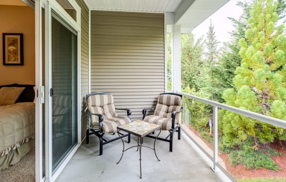 a patio with two chairs and a coffee table at Madison Sierra Sun, Puyallup, WA
