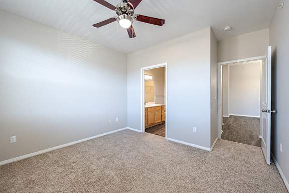 A room with a ceiling fan and carpeted floor at Vistas at Jackson Creek, Monument, 80132