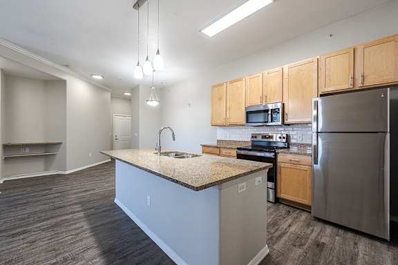 A kitchen with a granite countertop and stainless steel appliances at Vistas at Jackson Creek, Monument