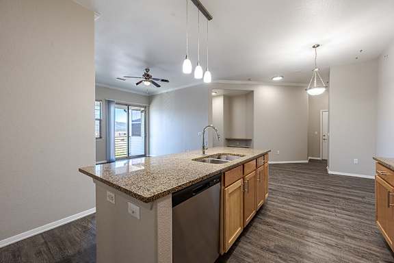 A kitchen with a granite countertop and stainless steel appliances at Jackson Creek, Monument, Colorado