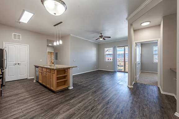 A spacious room with a kitchen island and wood flooring at Jackson Creek, Colorado, 80132