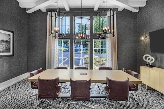 A conference room with a long table and chairs at Folksong Apartments, Georgia 30542