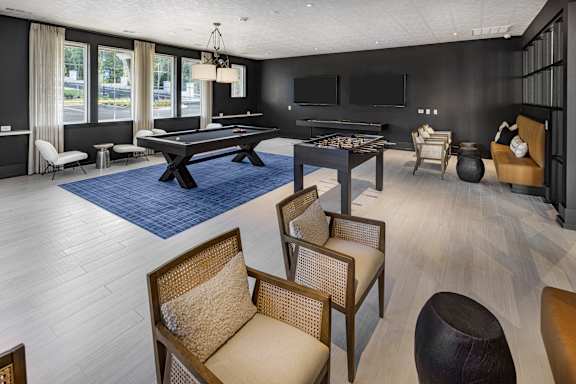 A room with a pool table and a television at Folksong Apartments, Flowery Branch, GA