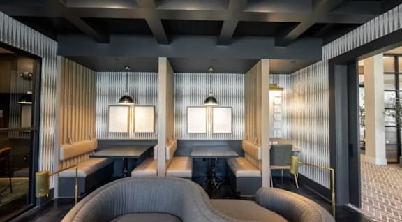 A modern room with a grey carpet and wooden walls.