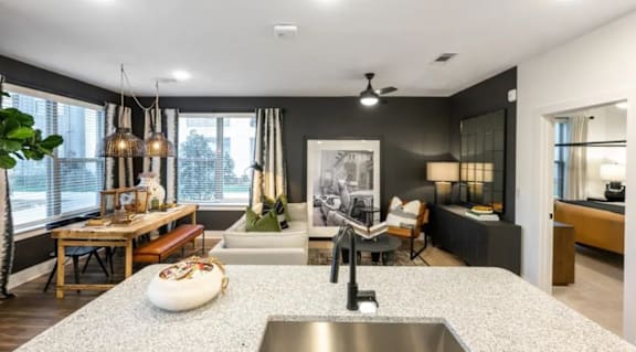 A modern kitchen with a large island and a dining area.