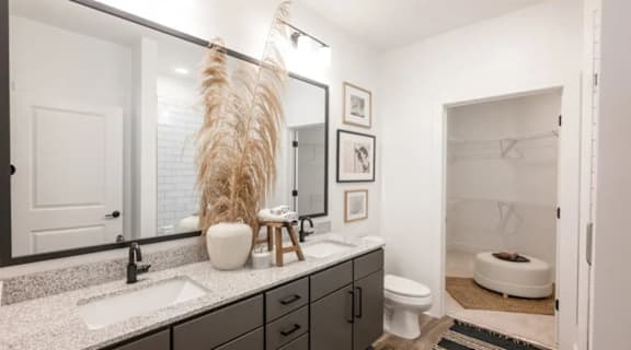 A bathroom with a white sink and a white toilet.