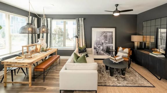 A modern living room with a dining table and a white sofa.