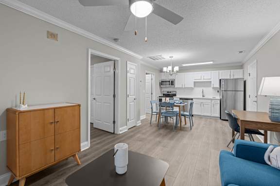 A kitchen with a dining table and chairs.