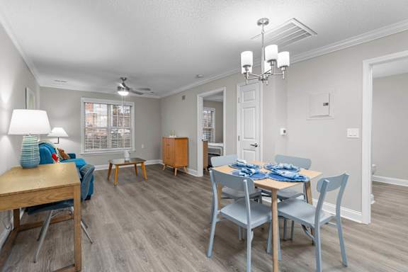 A dining room with a table set for four.