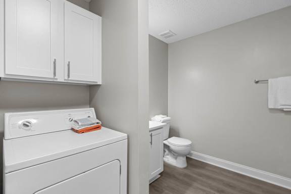 A white washing machine and dryer in a laundry room.