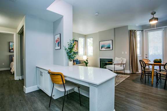 A kitchen with a white counter and orange chairs. at Octave Apartments, Nevada