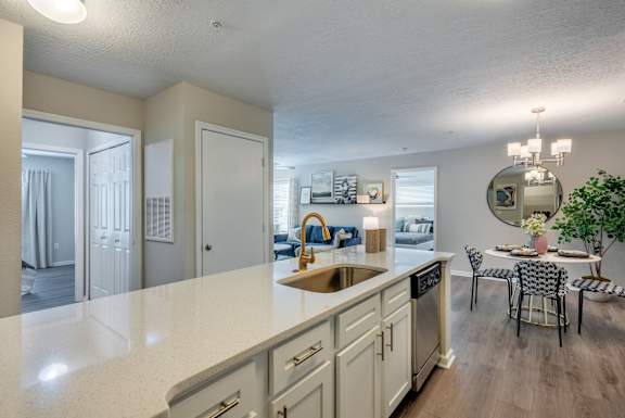 A kitchen with a dining table and chairs.