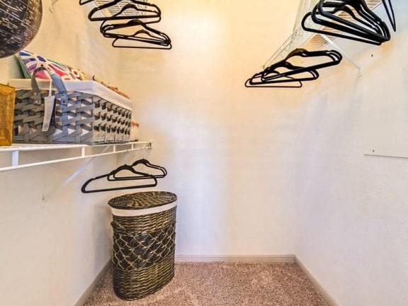 a closet with shoes on the wall and a basket