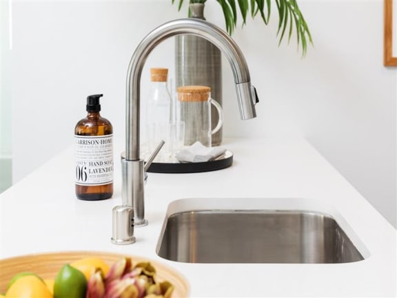 Bathroom stainless steel sink and faucet at the perch, Los Angeles, CA 90065