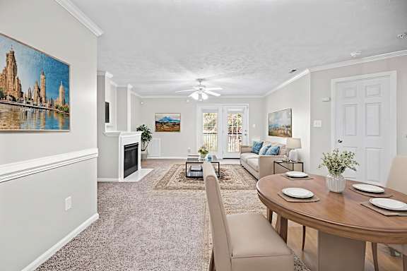 A living room with a fireplace and a painting on the wall.