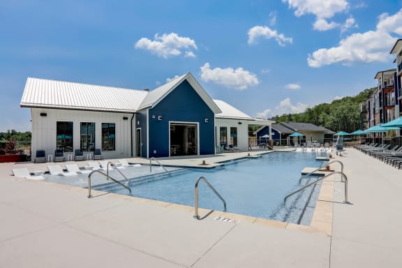 a swimming pool with a blue building in the background