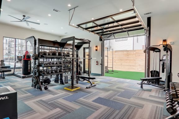 a home gym with weights and a punching bag
