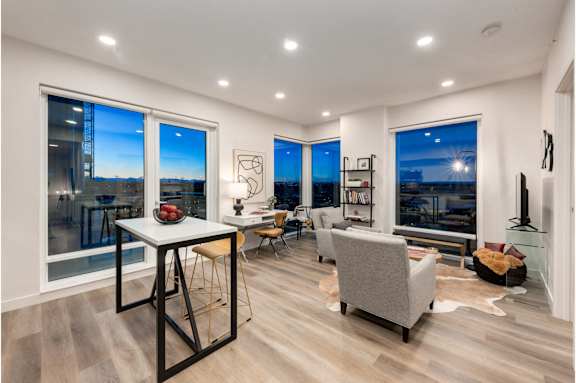 A modern living room with a dining table and chairs.