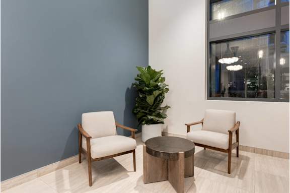 Two chairs and a table are in a room.