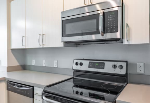 Kitchen with cabinets and white interior as well as appliancesat Canalside, Augusta