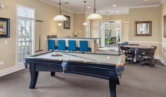 Billiards room with pool table and bar seating at Ansley Place Apartments, Louisiana, 70360