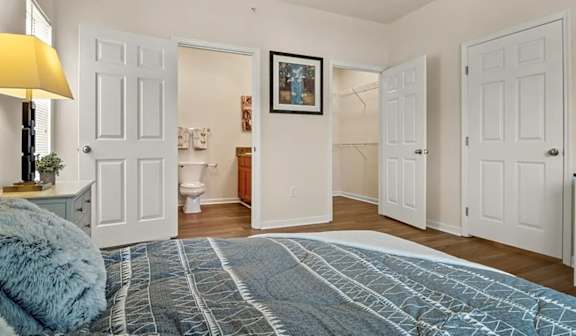 Primary bedroom with walk-in closet and bathroom access at Ansley Place Apartments, Houma, LA