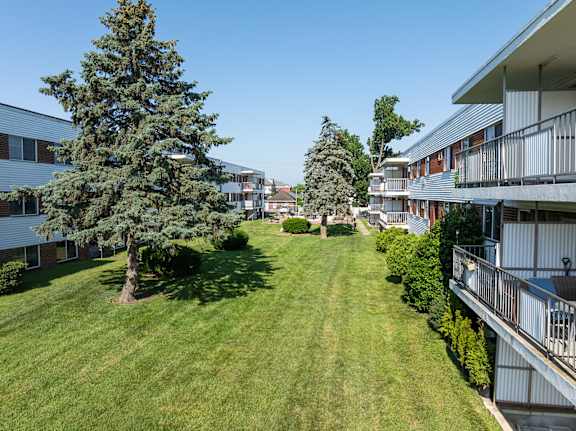A grassy area in front of apartment buildings.