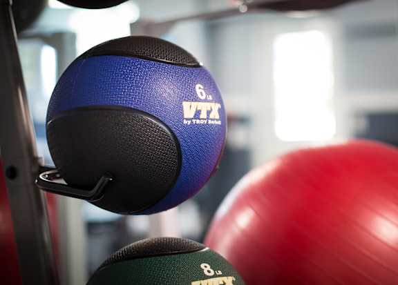 A blue and black weighted ball with the letters VTK on it.