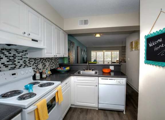 Kitchen at Town Place Apartments featuring a built-in dishwasher and garbage disposal for everyday convenience.
