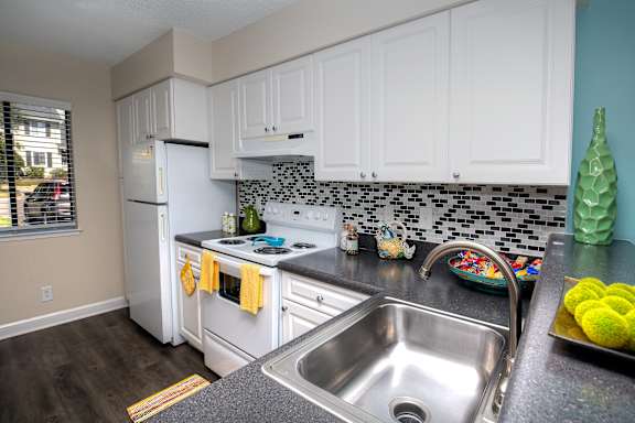 Kitchen at Town Place Apartments featuring a full-size refrigerator, modern cabinetry, and functional layout for everyday living.
