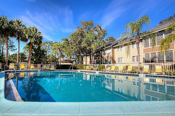 Community swimming pool at Town Place Apartments showcasing the newly installed pool deck completed in 2026, with lounge seating and outdoor relaxation space.