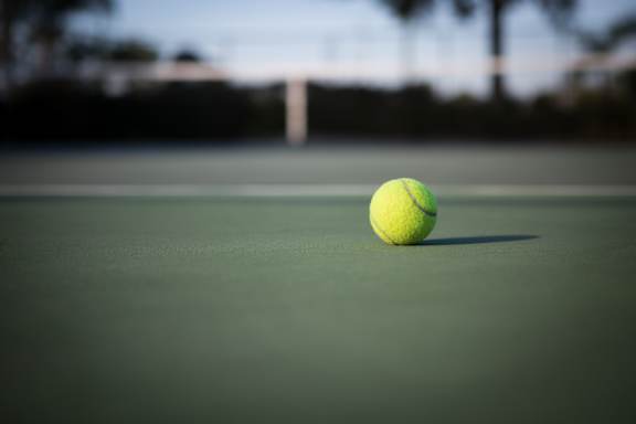 A tennis ball is on a tennis court.
