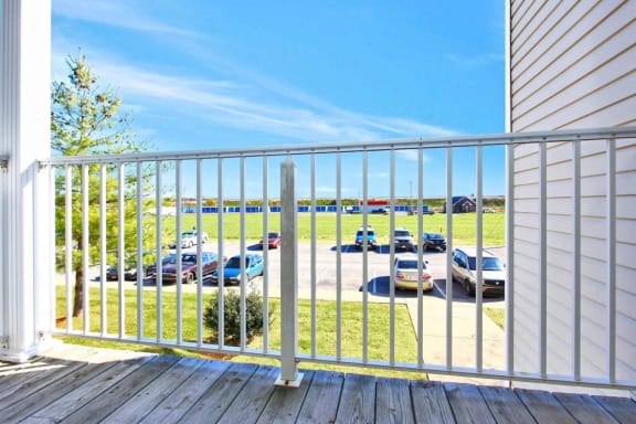 a balcony with a view of a parking lot with cars at Morris Estates Apartments in Hopkinsville, KY 42240