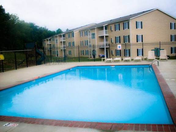 A swimming pool in front of a building.