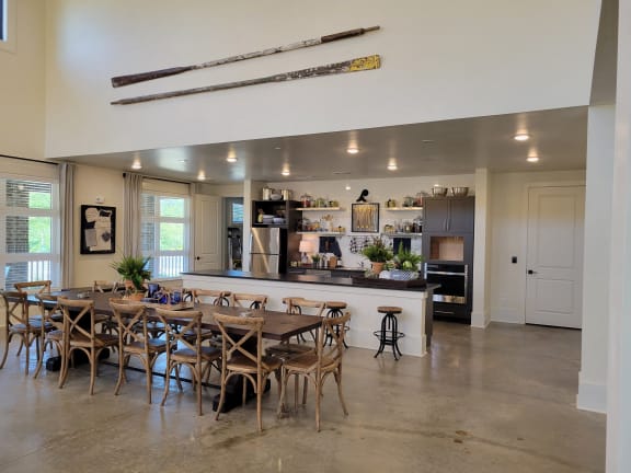 the dining room and kitchen of a home with a table and chairs and a bar