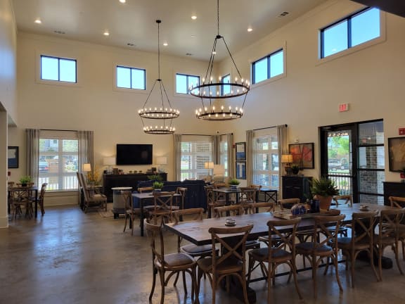 a large dining room with tables and chairs and chandeliers