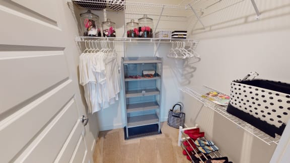 a small walk in closet with a white door and blue walls