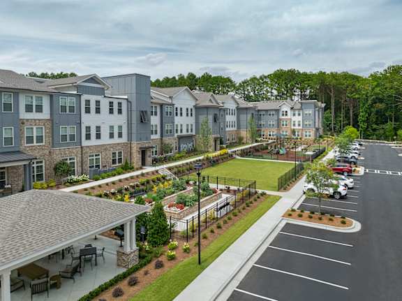 A large building with a parking lot in front of it.