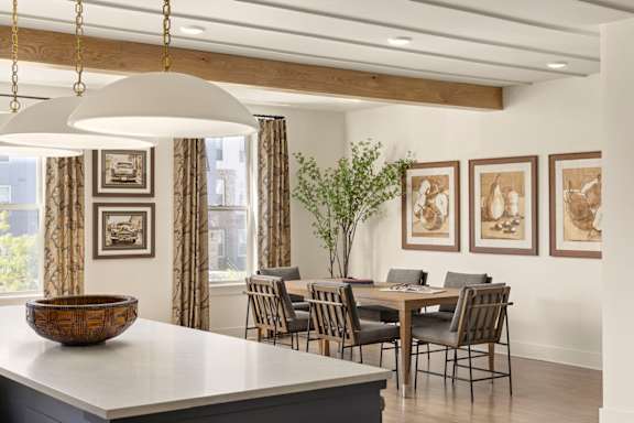 A dining room with a table set for four.