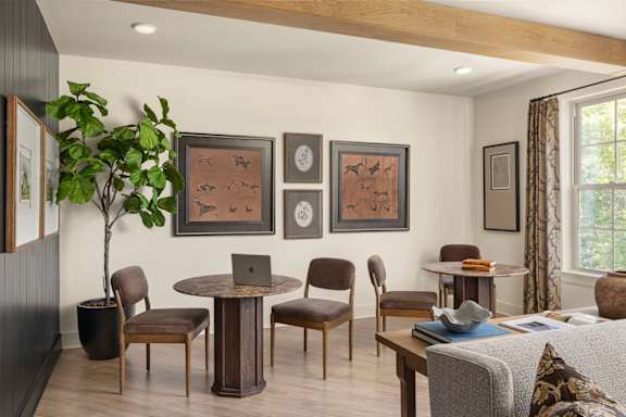 A living room with a round table and chairs.