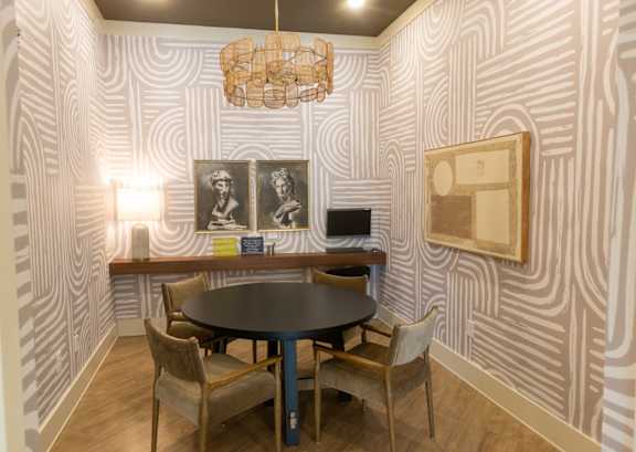 A dining room with a round table and chairs.